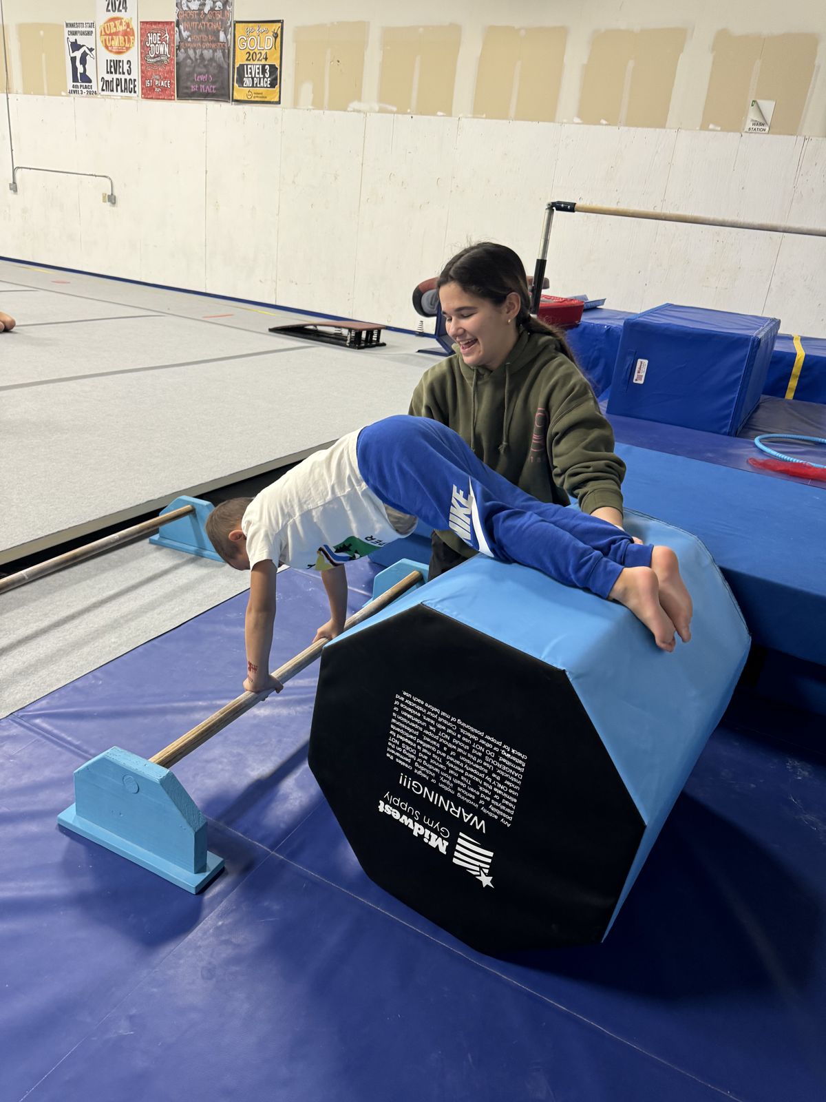 A Lake Point coach working one-on-one with a gymnast