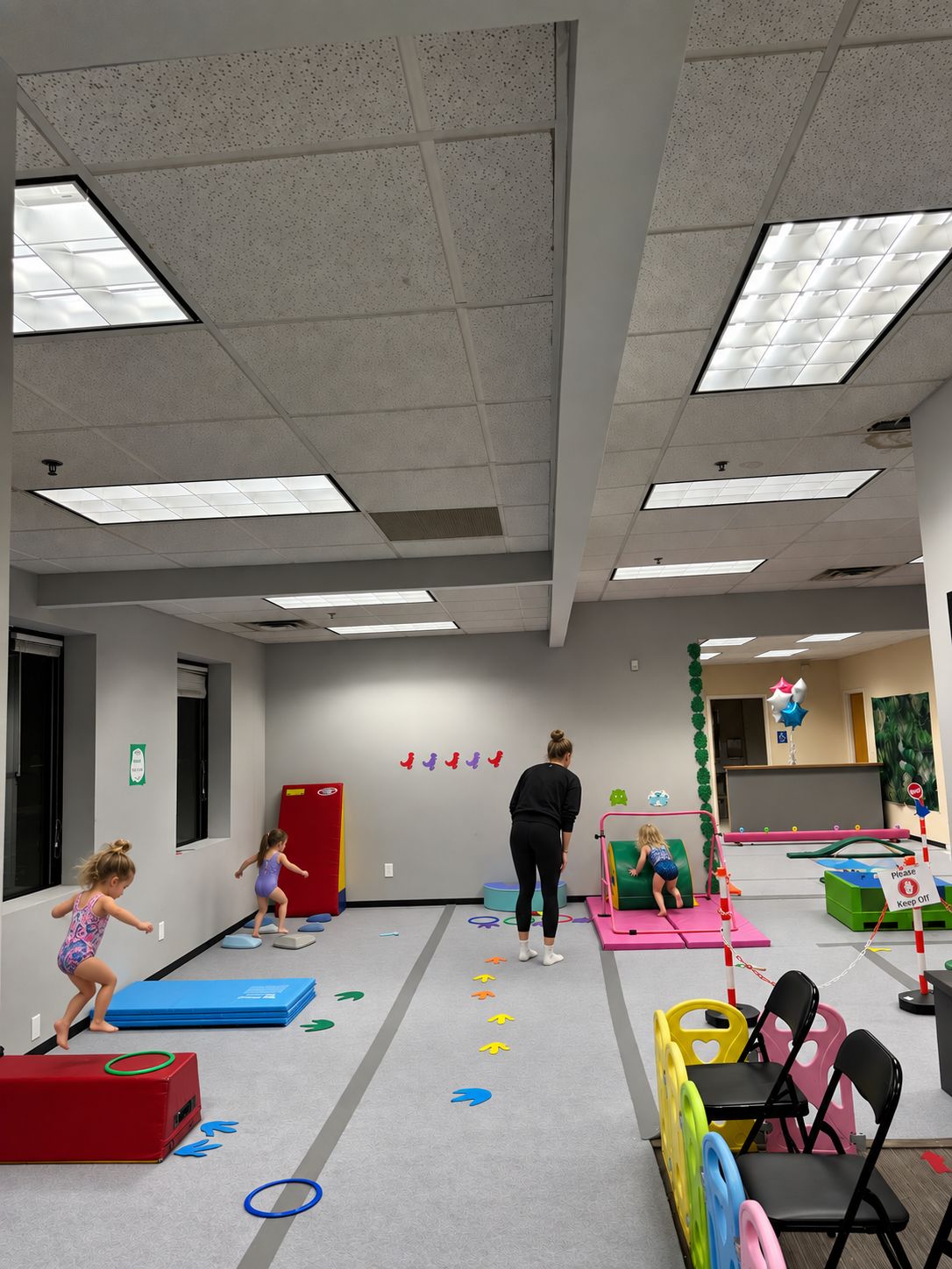 Preschoolers moving through an obstacle course with their coach