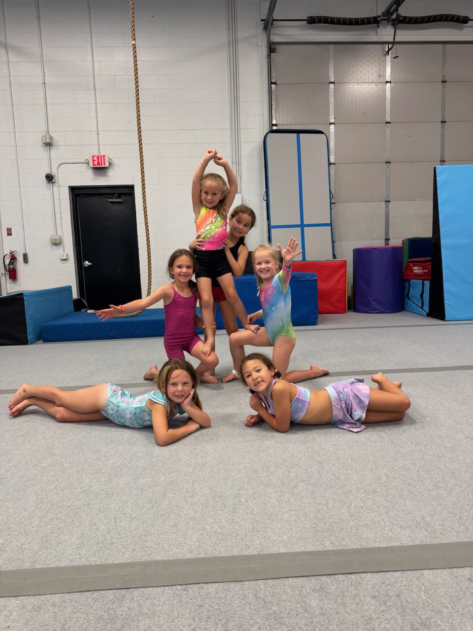 Gymnasts posing in a fun pyramid during rec class